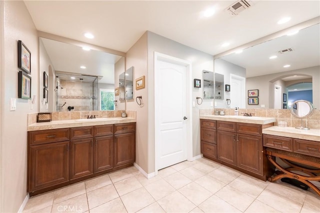 full bathroom with vanity, a walk in shower, visible vents, and tile patterned flooring