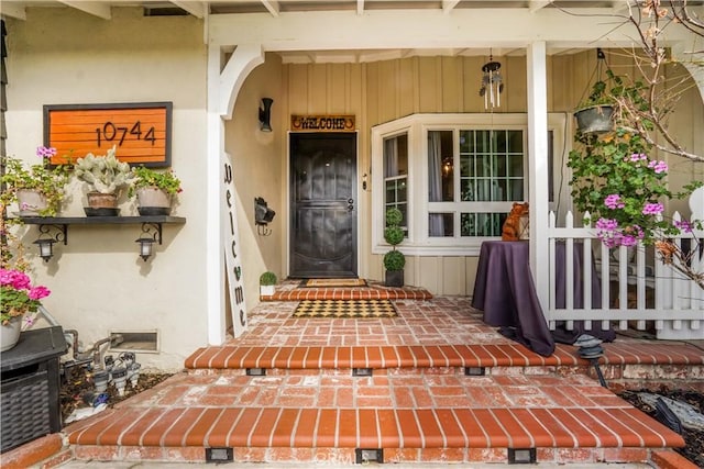 doorway to property with crawl space, covered porch, and stucco siding