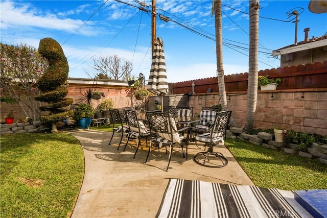 view of patio with outdoor dining area and a fenced backyard