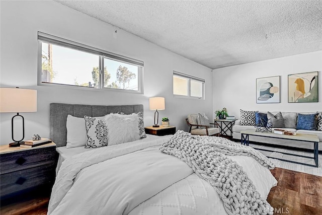 bedroom with wood finished floors and a textured ceiling