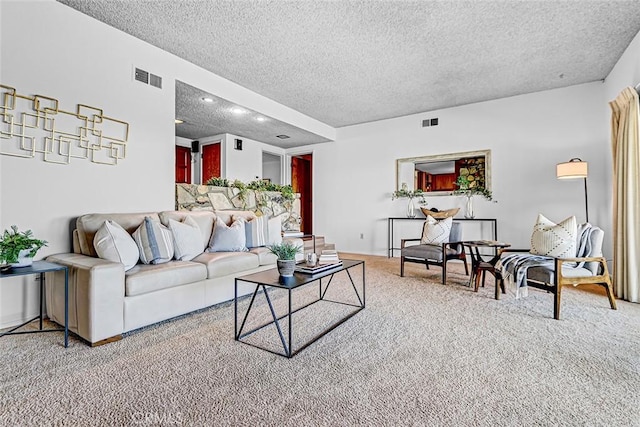 carpeted living room with visible vents and a textured ceiling