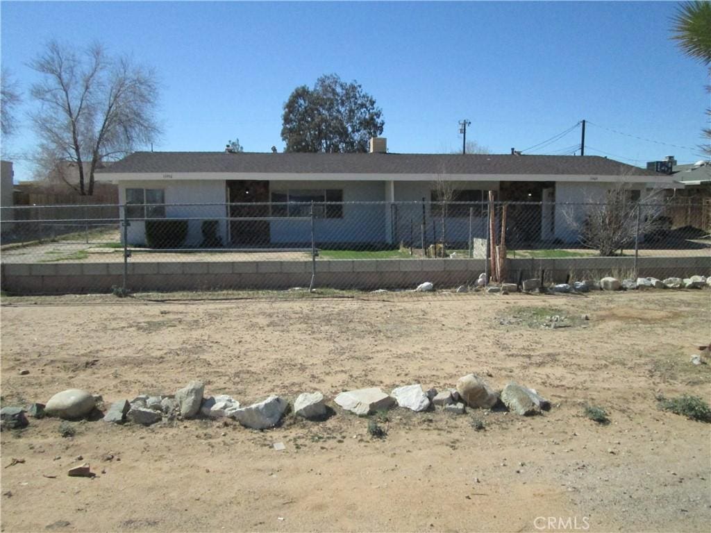 ranch-style home with fence