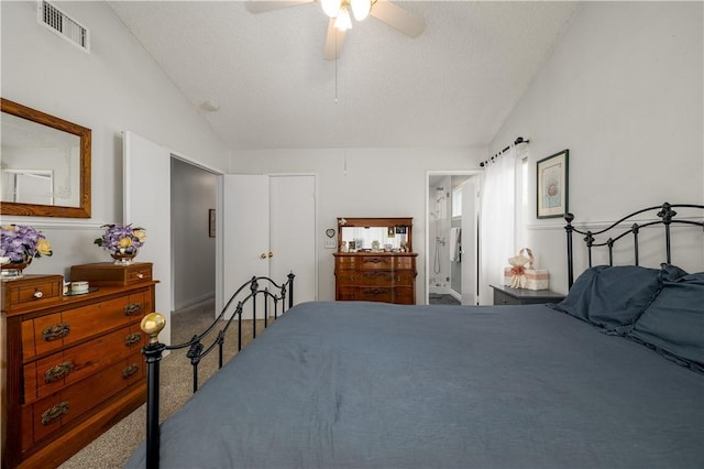 bedroom with visible vents, ensuite bath, lofted ceiling, and carpet floors