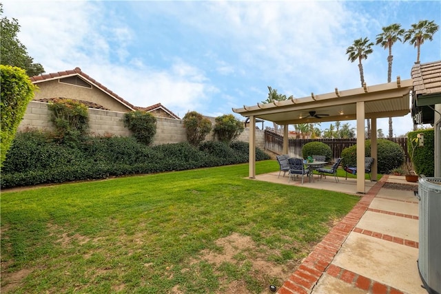 view of yard with a patio area, central AC, and a fenced backyard