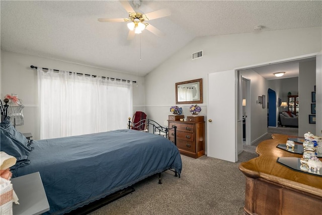 bedroom featuring visible vents, a textured ceiling, carpet, lofted ceiling, and ceiling fan