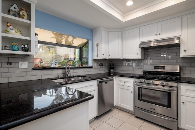 kitchen featuring under cabinet range hood, white cabinets, stainless steel appliances, and a sink