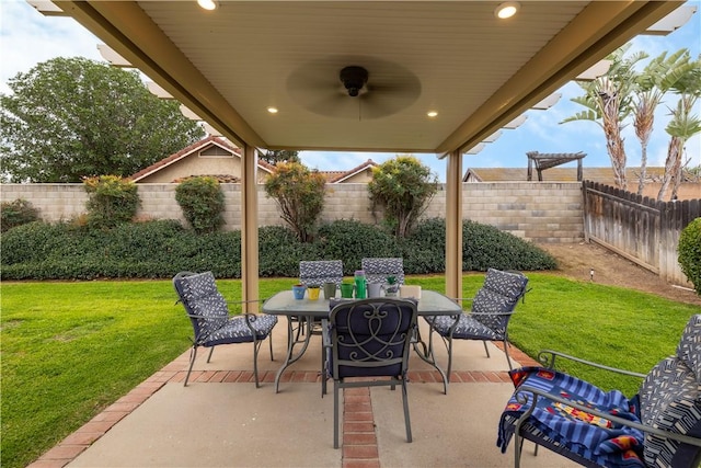 view of patio with outdoor dining area, a fenced backyard, and ceiling fan