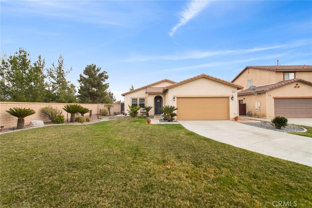 mediterranean / spanish house with a front yard, fence, an attached garage, stucco siding, and concrete driveway