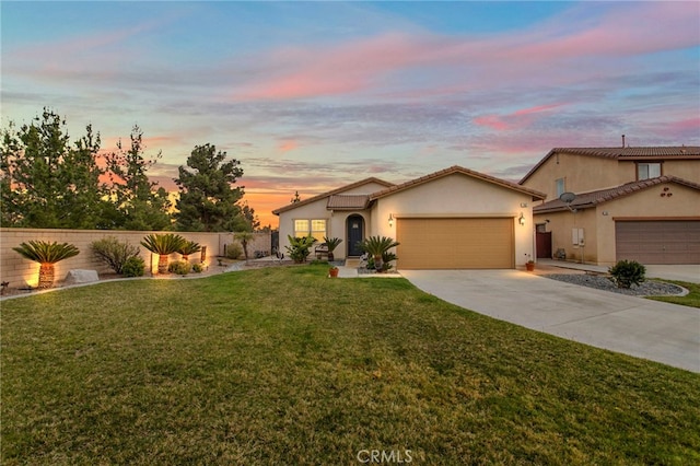 ranch-style home with stucco siding, driveway, a front lawn, fence, and a garage