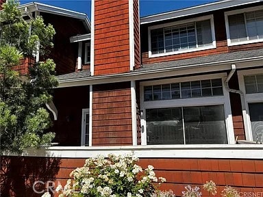 view of side of home with an attached garage and a chimney