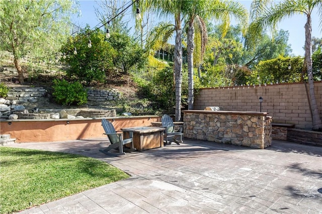 view of patio / terrace featuring a fire pit, area for grilling, and fence