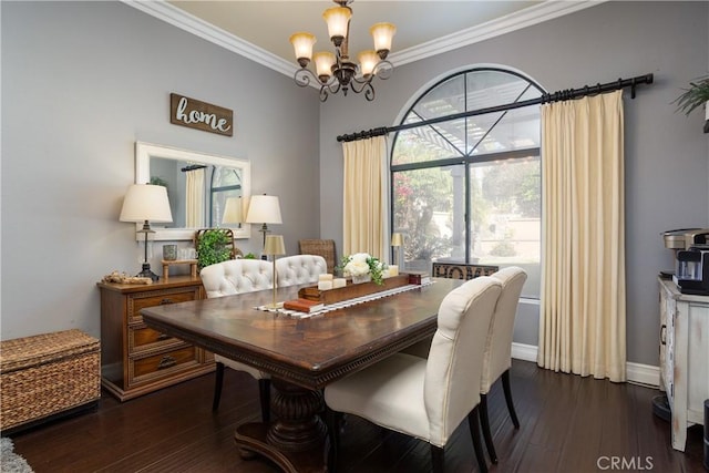 dining room with dark wood finished floors, crown molding, baseboards, and a chandelier