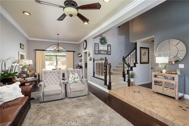 living room featuring stairway, baseboards, wood finished floors, and crown molding