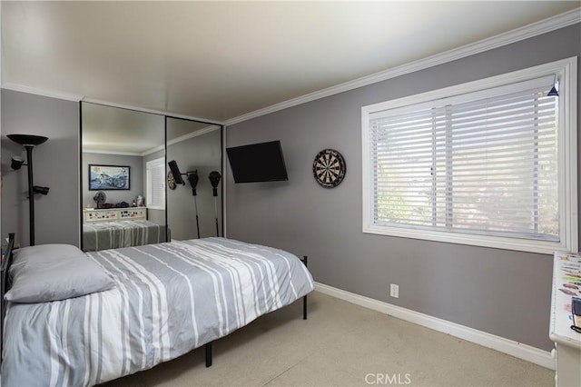 bedroom featuring carpet, baseboards, a closet, and ornamental molding