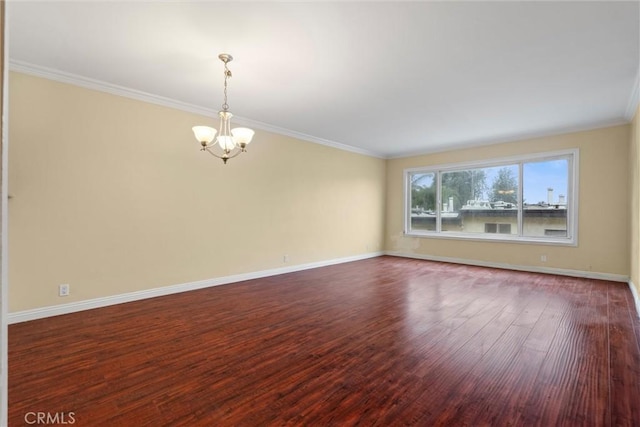 unfurnished room featuring dark wood-style floors, baseboards, crown molding, and an inviting chandelier