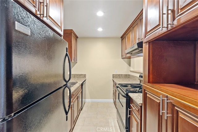 kitchen with black appliances, under cabinet range hood, light tile patterned floors, baseboards, and light stone countertops