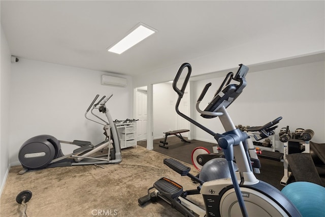 workout area featuring a wall mounted air conditioner and baseboards