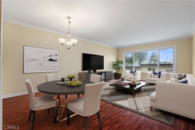 dining space featuring a notable chandelier, crown molding, baseboards, and wood finished floors