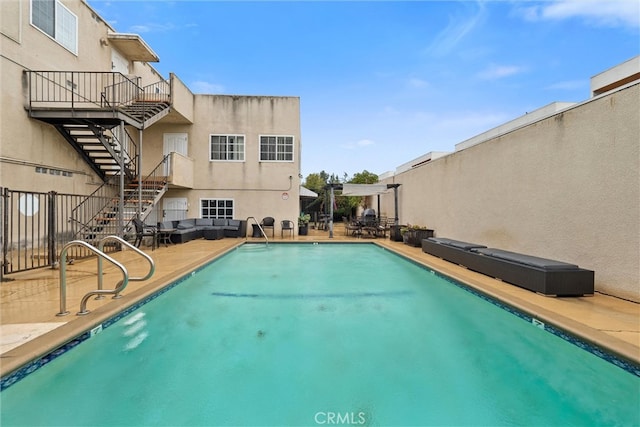 community pool with stairway and a patio