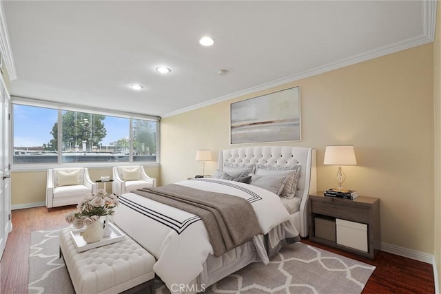 bedroom with crown molding, recessed lighting, wood finished floors, and baseboards