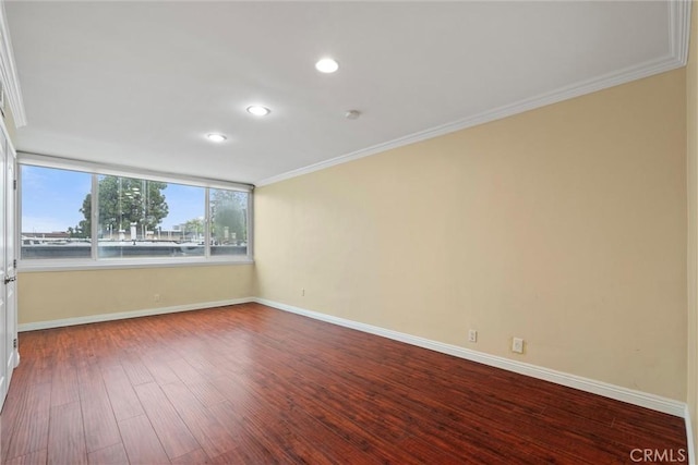 unfurnished room with recessed lighting, baseboards, dark wood-style flooring, and crown molding