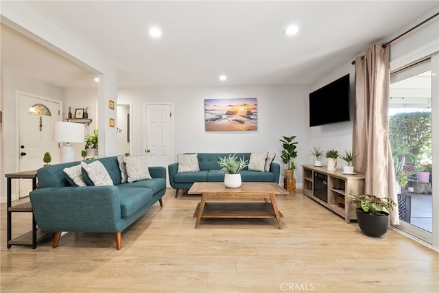 living area featuring light wood finished floors and recessed lighting