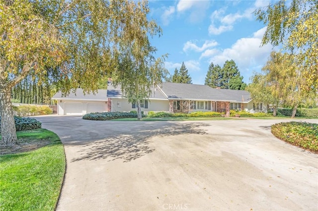 ranch-style house featuring driveway and a garage