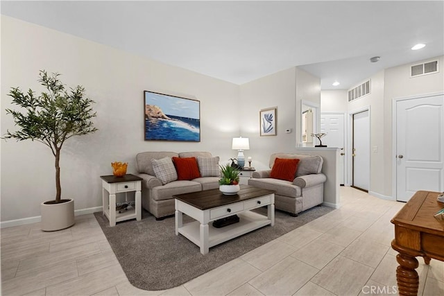 living area featuring baseboards, visible vents, and recessed lighting