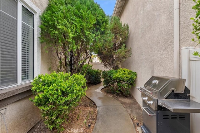 exterior space featuring grilling area and fence