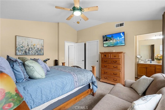 bedroom featuring visible vents, ceiling fan, light carpet, ensuite bath, and vaulted ceiling
