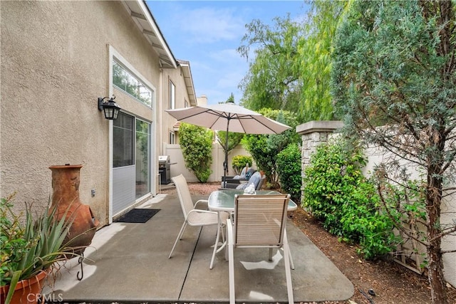 view of patio / terrace featuring outdoor dining space, area for grilling, and fence