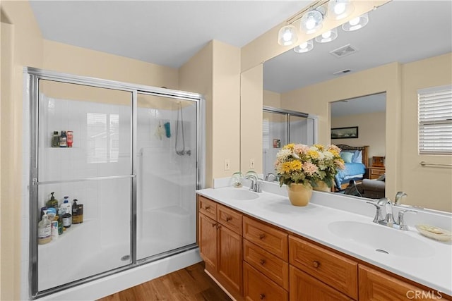 full bath with a sink, a shower stall, ensuite bath, and visible vents