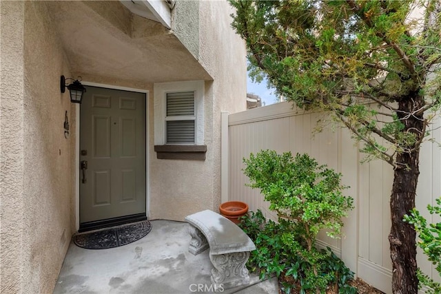 property entrance with stucco siding