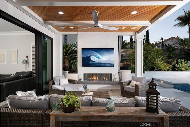 view of patio featuring an outdoor living space with a fireplace and a ceiling fan