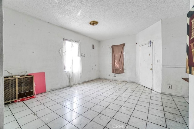 spare room featuring a textured ceiling