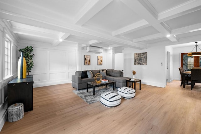 living room with a decorative wall, light wood-style flooring, beamed ceiling, and a wall mounted air conditioner