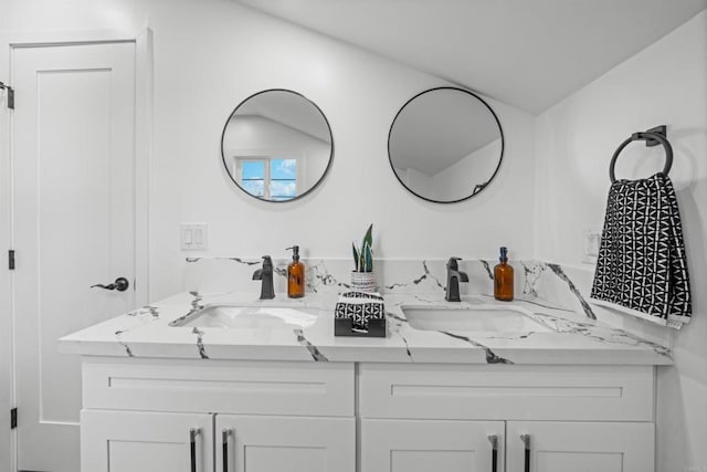 full bath with double vanity and a sink