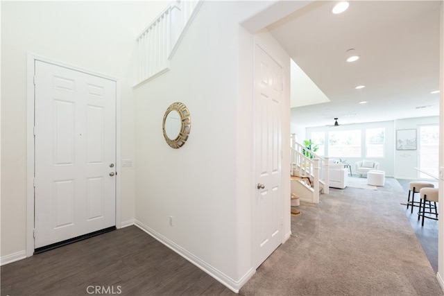 entrance foyer with recessed lighting, stairs, baseboards, and wood finished floors