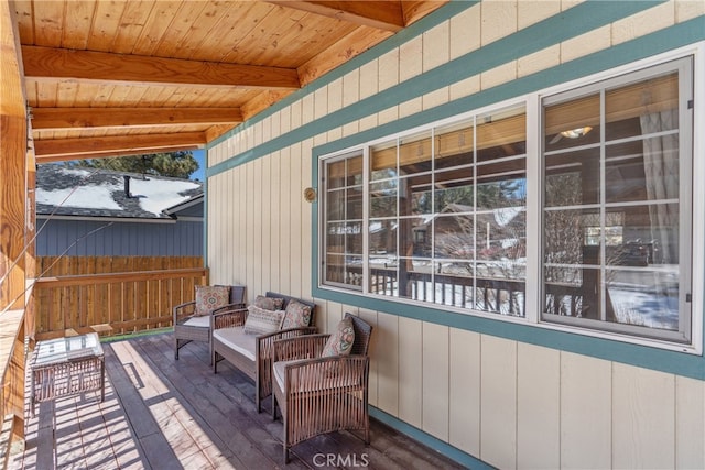 wooden deck featuring an outdoor living space and fence