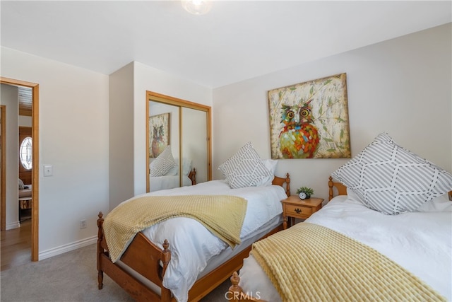 bedroom featuring carpet, a closet, and baseboards