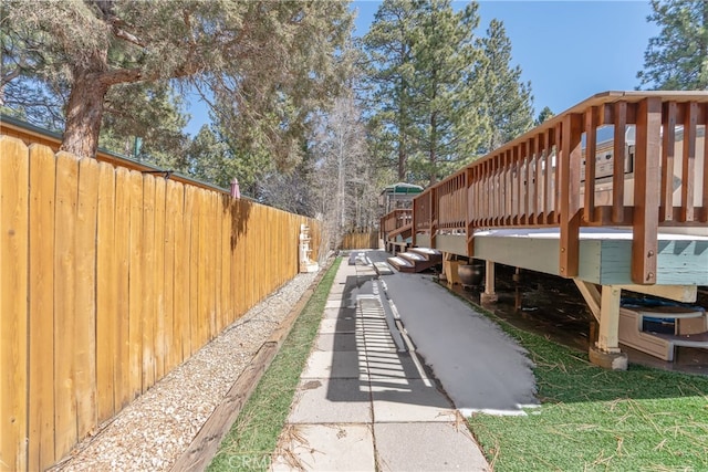 view of home's community with fence and a wooden deck