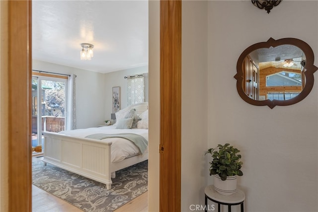 bedroom featuring wood finished floors and access to outside