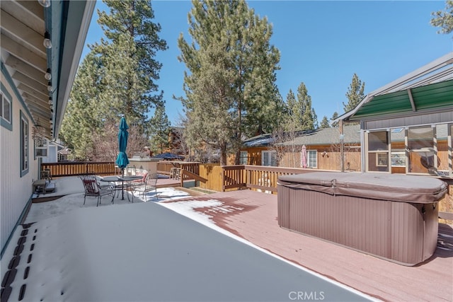 exterior space with a hot tub, outdoor dining area, and a deck