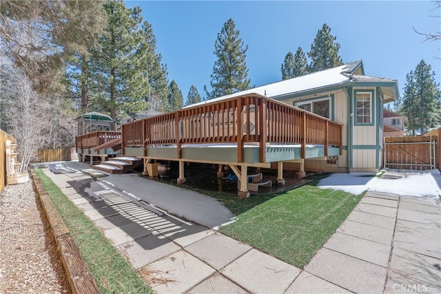 exterior space with a gate, a wooden deck, and fence