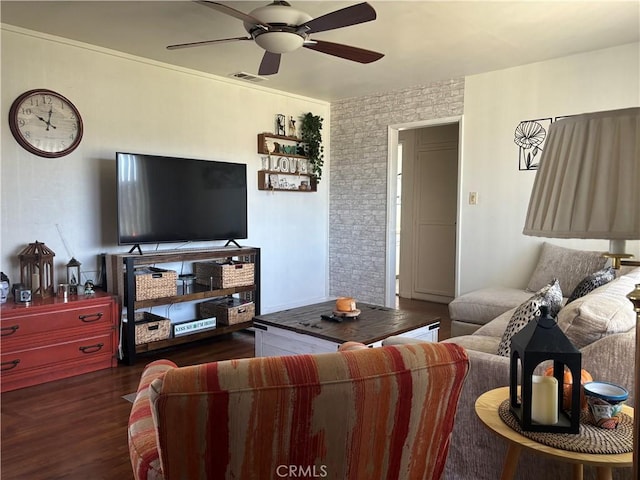 living room with visible vents, ceiling fan, and wood finished floors