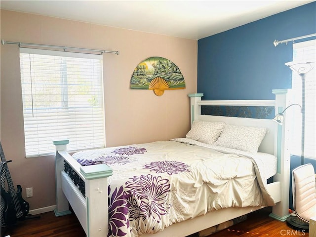 bedroom featuring baseboards and dark wood finished floors