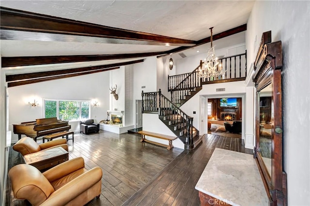 5441 Calvin Ave, Tarzana, CA 91356 - living room featuring high vaulted ceiling, a glass covered fireplace, stairs, wood-type flooring, and a notable chandelier
