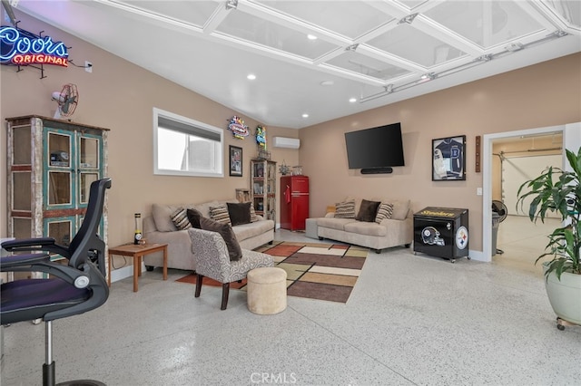 living area with recessed lighting, an AC wall unit, and speckled floor