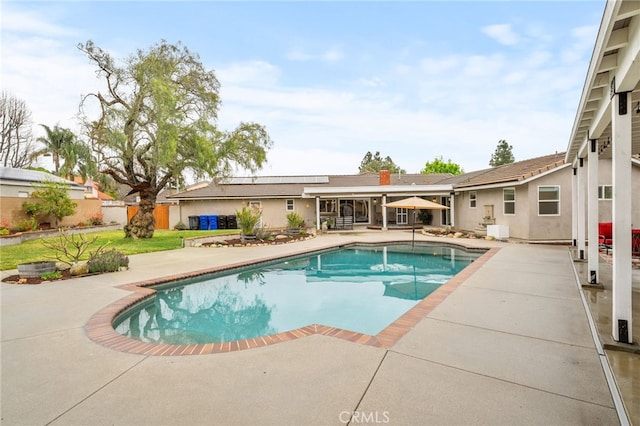 view of pool with a patio area, a fenced in pool, and fence