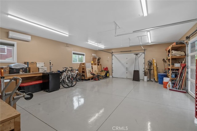 garage with a workshop area and a wall unit AC